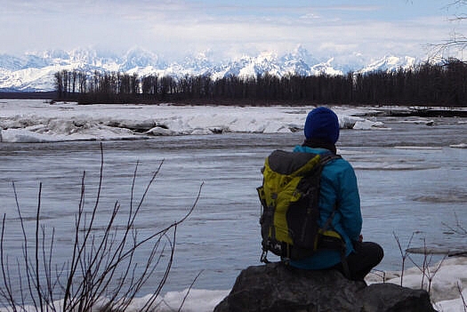 Above, the Alaska Range viewed from Talkeetna, Susitna River, by some standards the 15th largest river in the United States. The spiky peak above Lisa's head is Mount Huntington, while Denali is back there in the clouds where it likes to live.